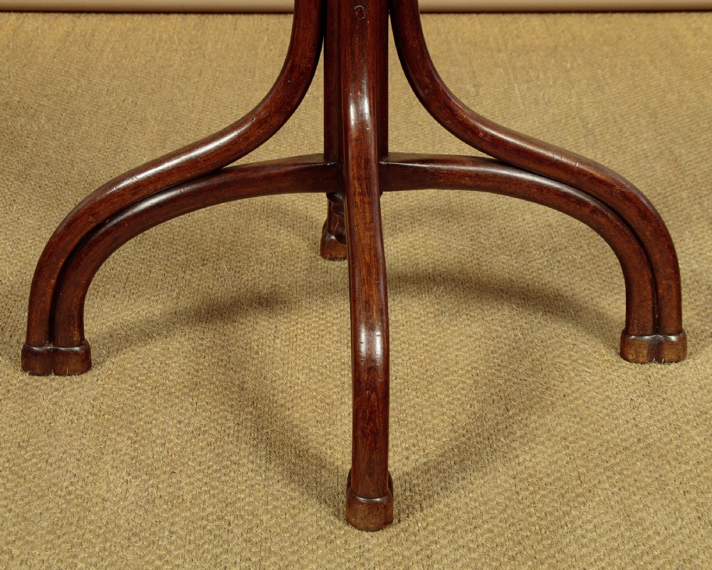 A pair of tall dark brown bentwood hallstands featuring curved coat hooks at the top and circular loops at the base for umbrellas. View IX