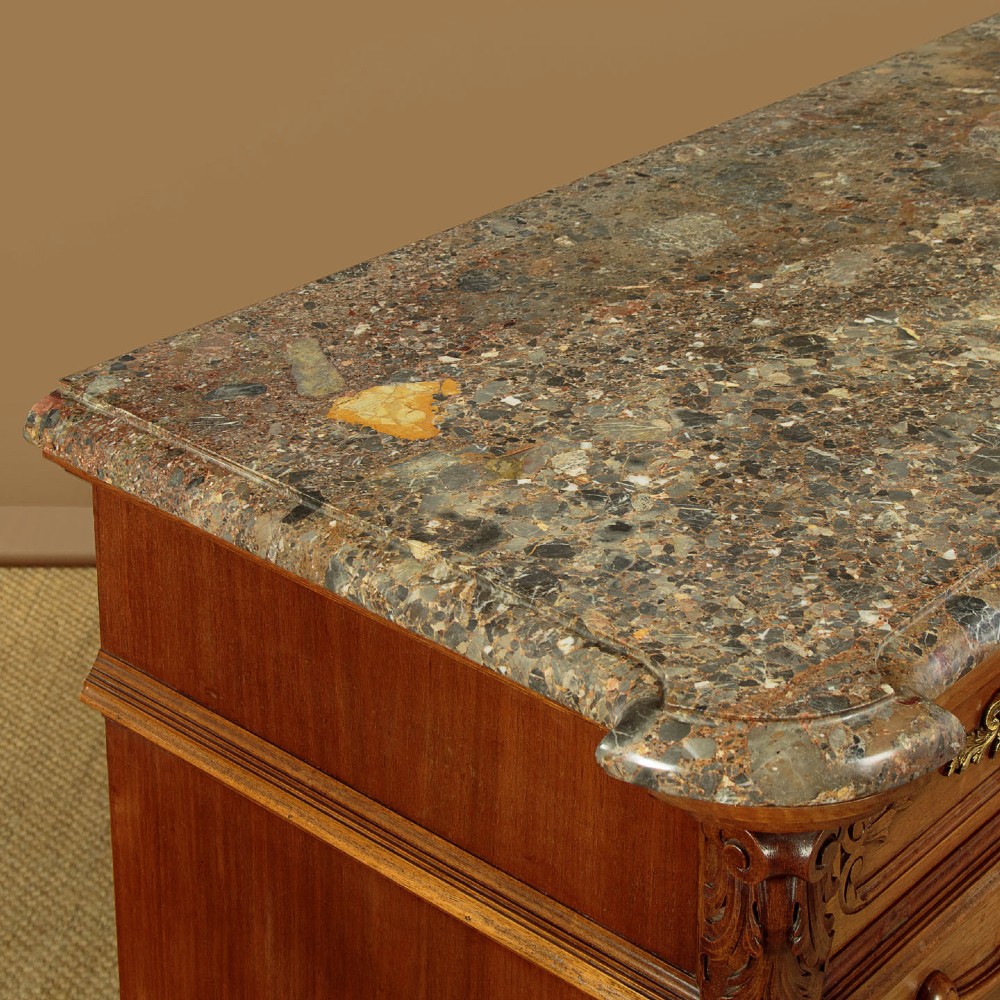 A French walnut sideboard featuring three top drawers, three panelled cabinet doors with central carved fruit motifs, brass handles, cabriole legs, and a fitted dark marble top. View VI