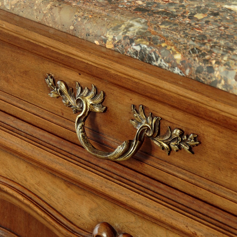 A French walnut sideboard featuring three top drawers, three panelled cabinet doors with central carved fruit motifs, brass handles, cabriole legs, and a fitted dark marble top. View VIII