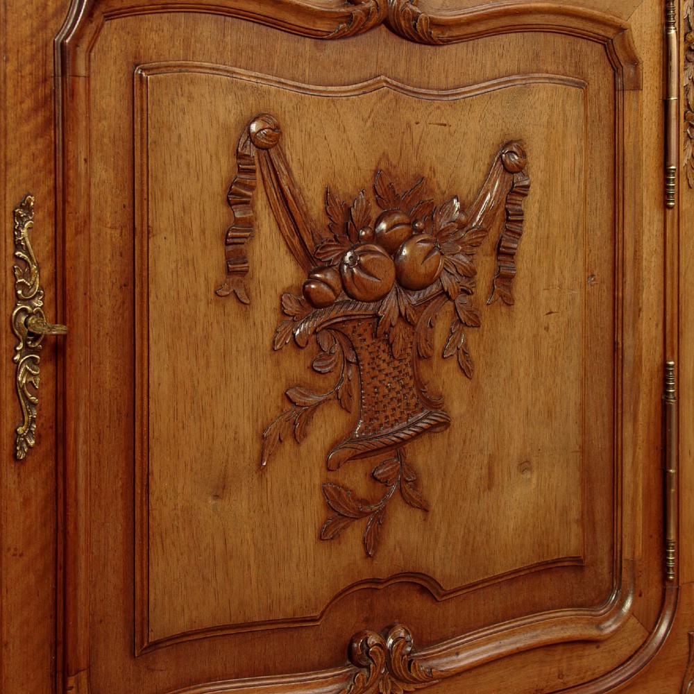 A French walnut sideboard featuring three top drawers, three panelled cabinet doors with central carved fruit motifs, brass handles, cabriole legs, and a fitted dark marble top. View X