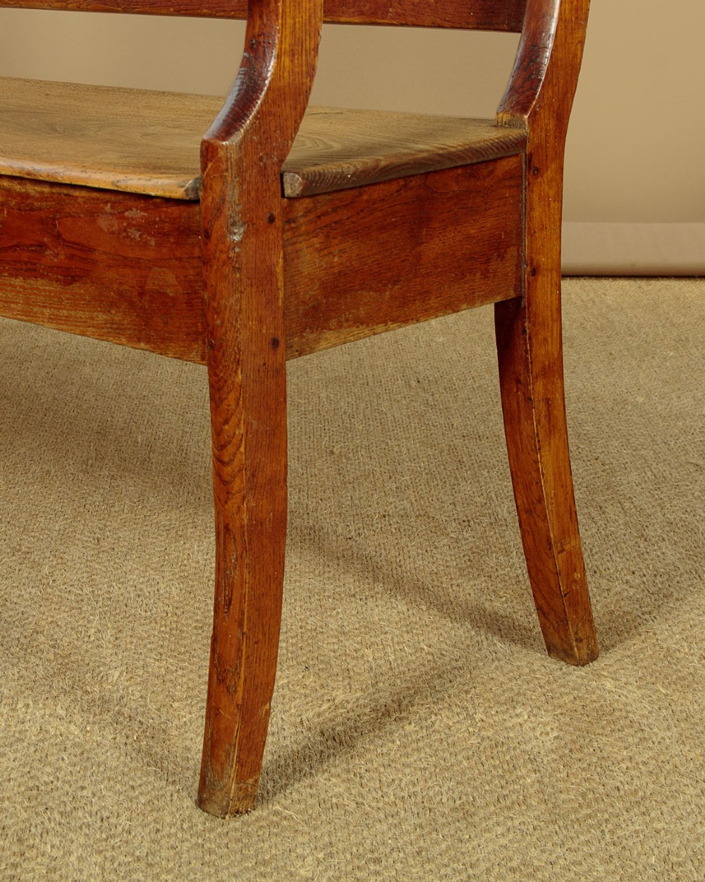 A nineteenth-century warm brown ash wooden hall bench featuring a backrest with seven pierced teardrop splats, scrolled armrests, and a solid plank seat. View VII