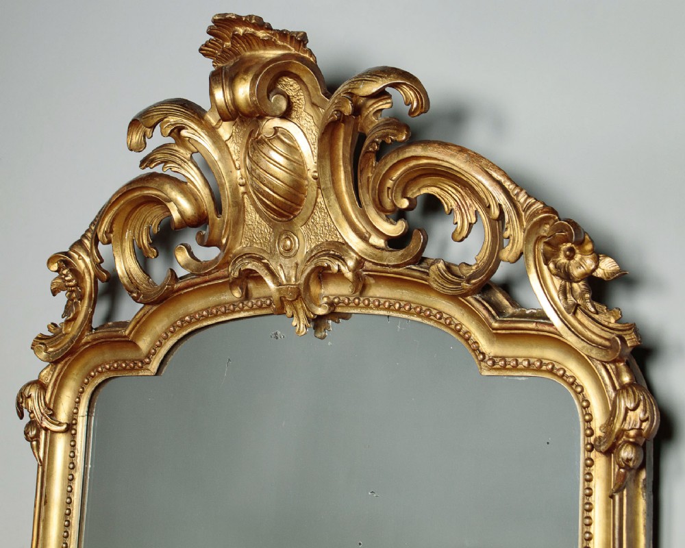 A large late Victorian giltwood overmantel mirror with an arched top, detailed beaded inner rim, and carved cresting featuring acanthus scrollwork. View III