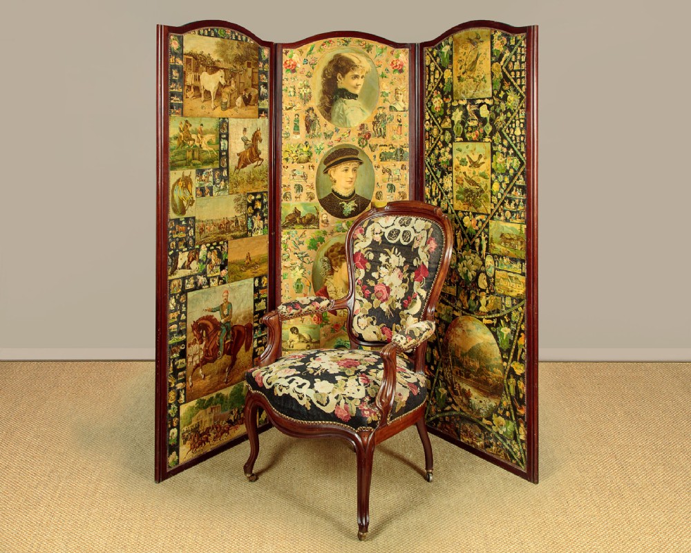 A late Victorian three-panel wooden folding screen covered in dense decoupage scrapwork featuring portraits, animals, and floral imagery. View II