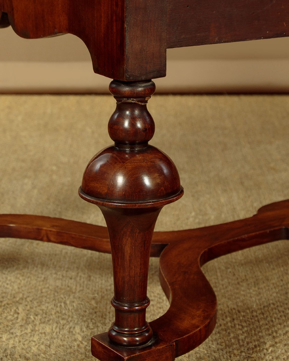 A 1930s Queen Anne Revival burr walnut chest on stand featuring multiple graduated drawers, decorative brass handles, turned legs, and a shaped apron. View X