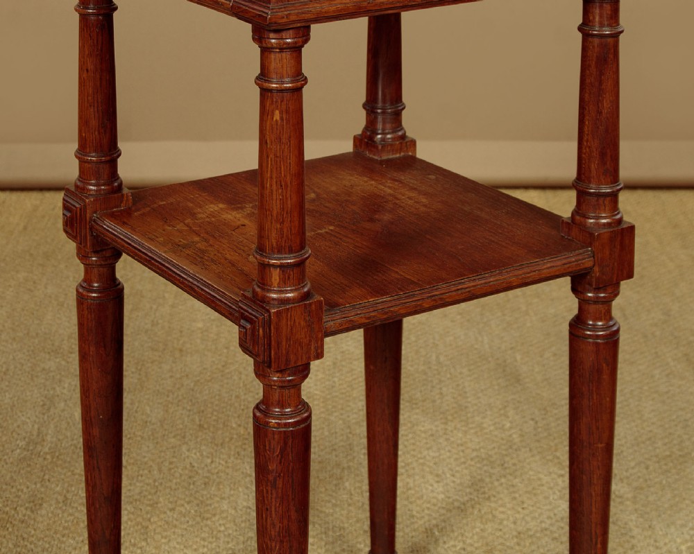 A pair of slender Edwardian oak lamp tables featuring inset marble tops, single drawers with brass ring pulls, turned tapered legs, and lower tier shelves. View XII