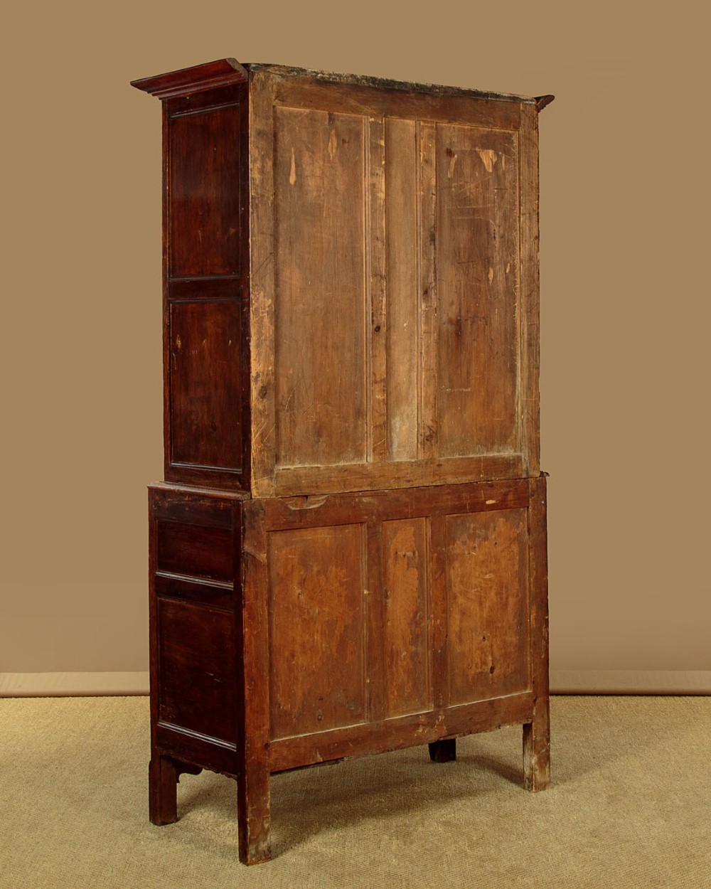 A two-part antique warm brown oak bread and cheese cupboard featuring upper doors with lattice ventilation fretwork over lower drawers and panelled cupboard doors. View XV