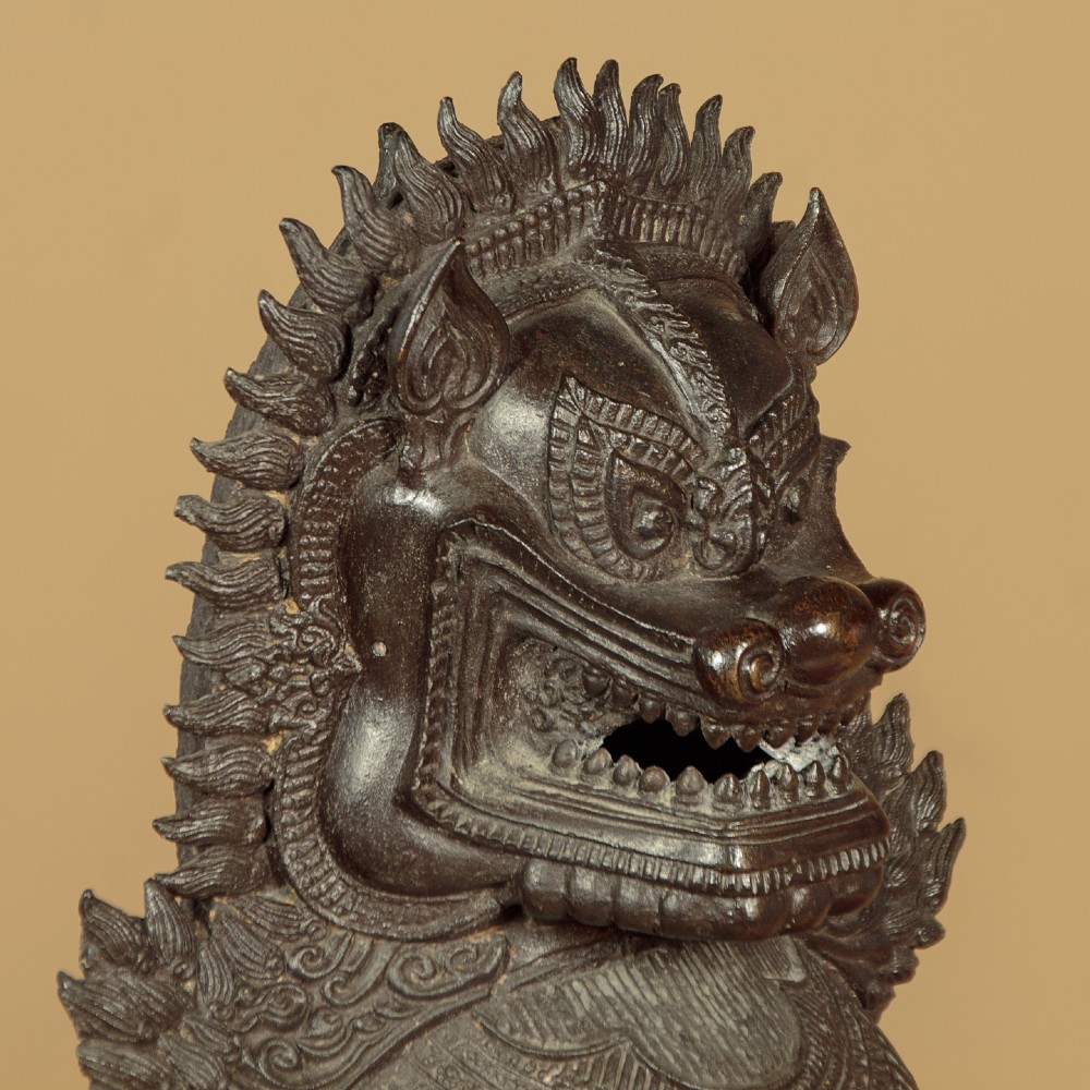 A pair of dark bronze temple lion statues sitting upright with intricate stylized manes and detailed ornamental chest bands. View VIII