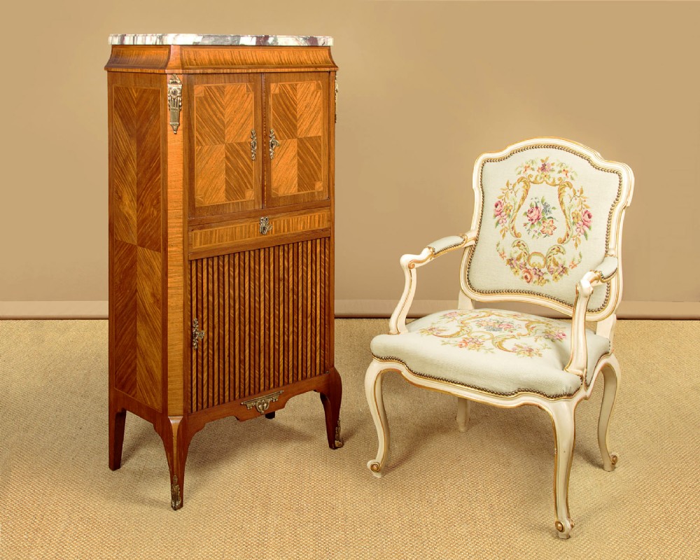 A tall Louis XVI style wooden side cabinet featuring geometric herringbone parquetry veneers, brass mounts, and a polished marble top. View II