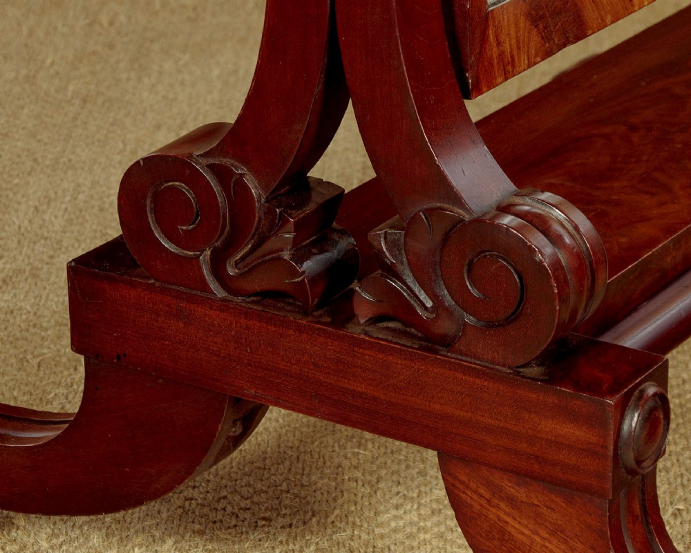 A 19th-century mahogany cheval mirror featuring a rectangular swivelling glass frame set between carved reeded uprights on scroll feet. View VIII