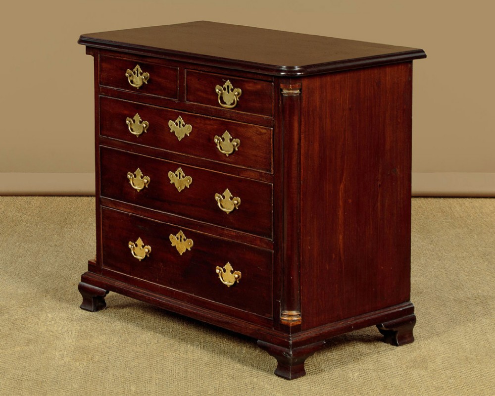 A small Georgian mahogany chest of drawers featuring two short and three long graduated drawers with brass batwing backplate handles and bracket feet. View III