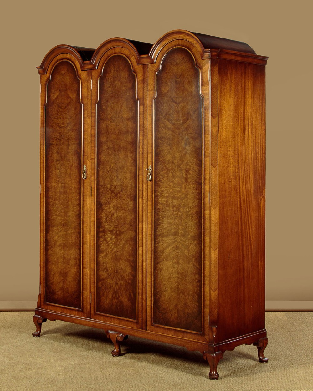 A 1920s Queen Anne style triple-door combination wardrobe made of figured burr walnut veneer with triple arched cornices and cabriole legs. View III