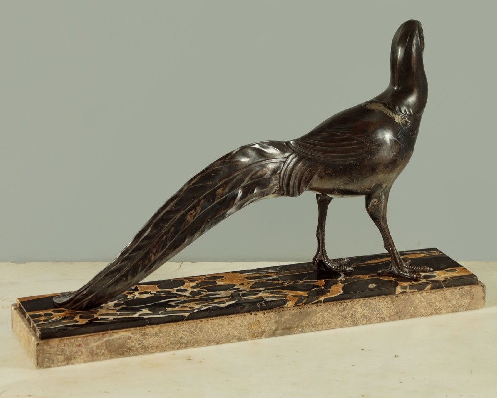 An Art Deco patinated metal sculpture of a long-tailed pheasant mounted on a rectangular black and gold marbled base. View III