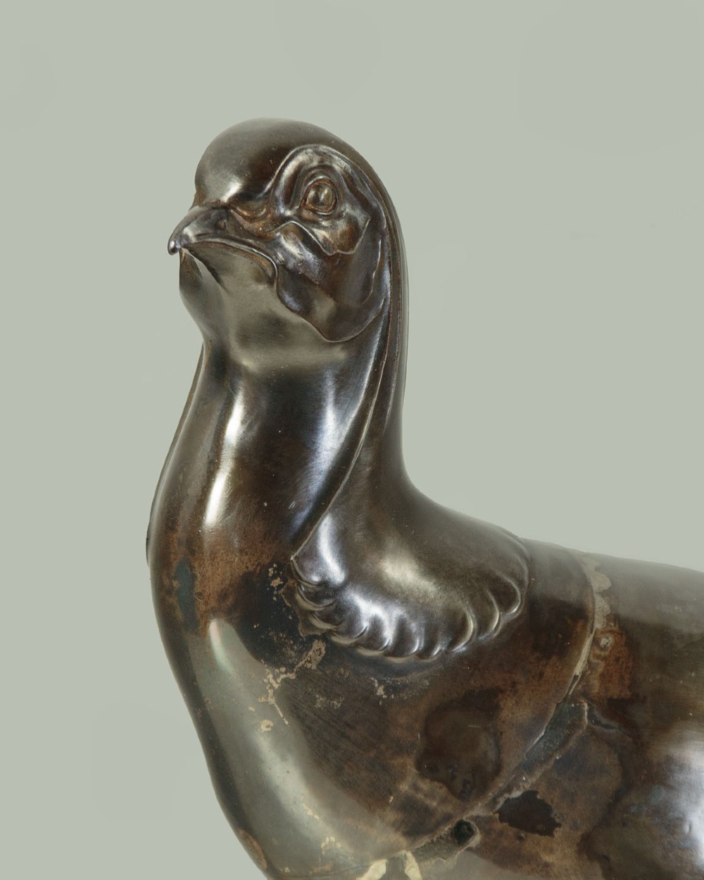 An Art Deco patinated metal sculpture of a long-tailed pheasant mounted on a rectangular black and gold marbled base. View IV