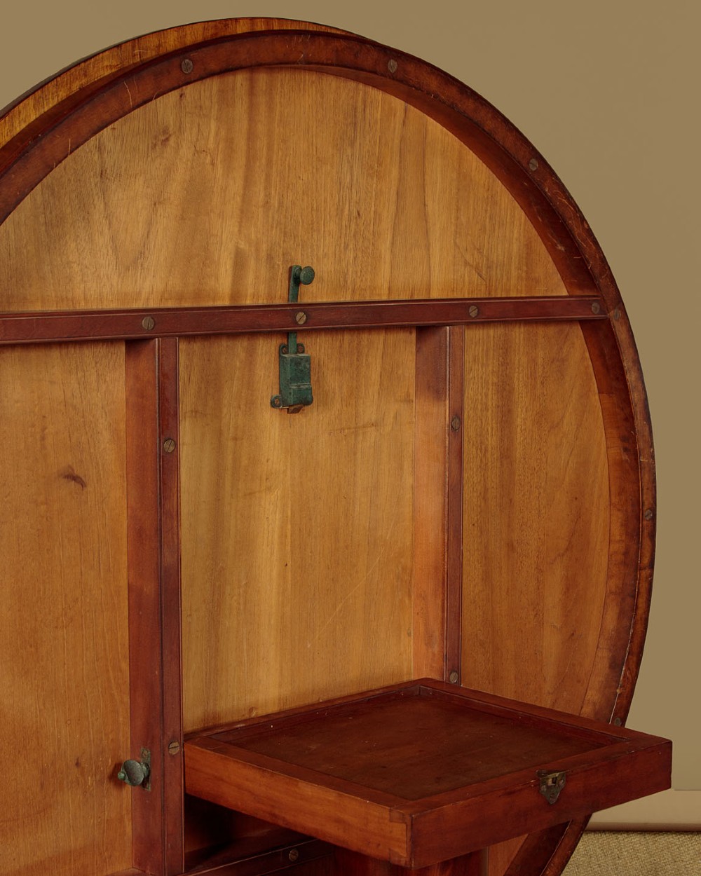 An early Victorian circular mahogany breakfast table with a central pedestal and lobed base supported by scroll feet on brass castors. View XI