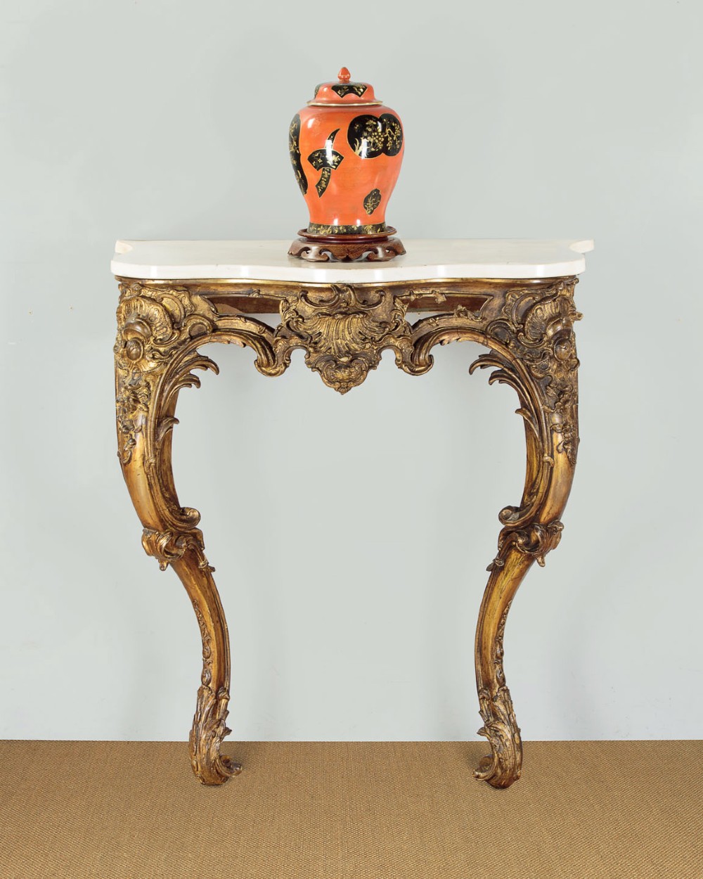A late 19th-century Rococo Revival giltwood console table featuring carved scrollwork, two cabriole legs, and a shaped white marble top. View II
