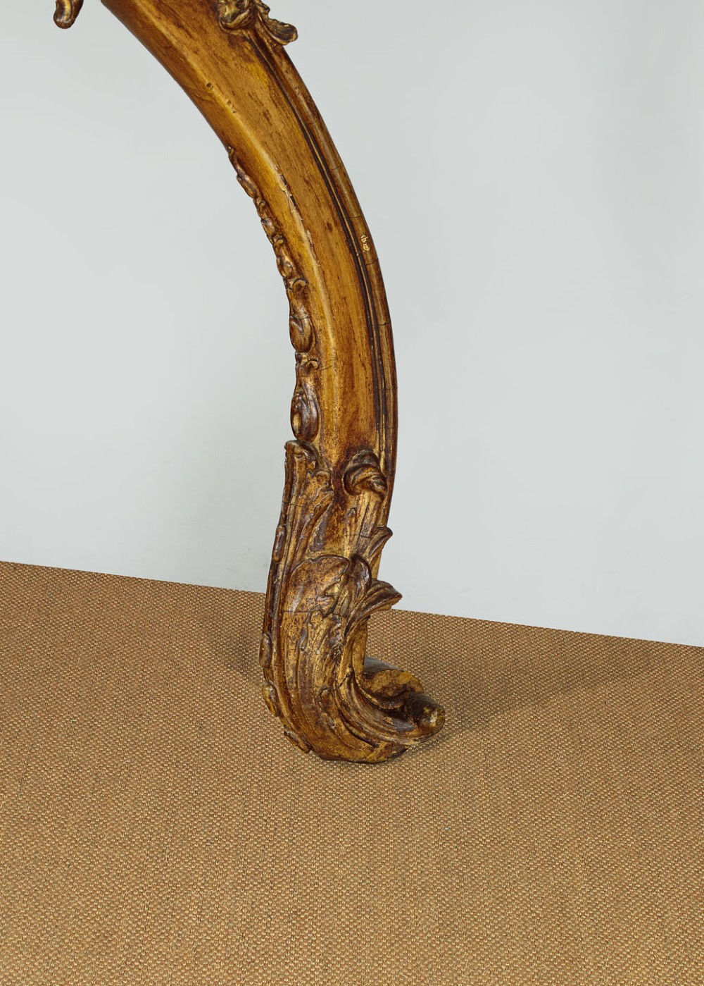 A late 19th-century Rococo Revival giltwood console table featuring carved scrollwork, two cabriole legs, and a shaped white marble top. View IX