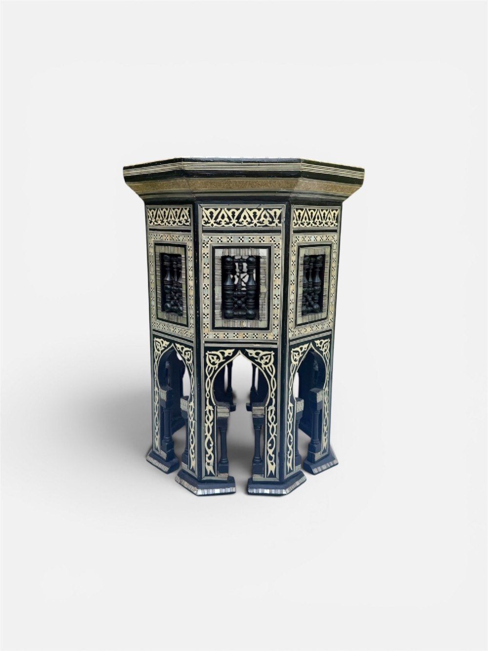 A 19th-century octagonal side table constructed from dark wood intricately inlaid with geometric mother-of-pearl star patterns and arched apron motifs. View III