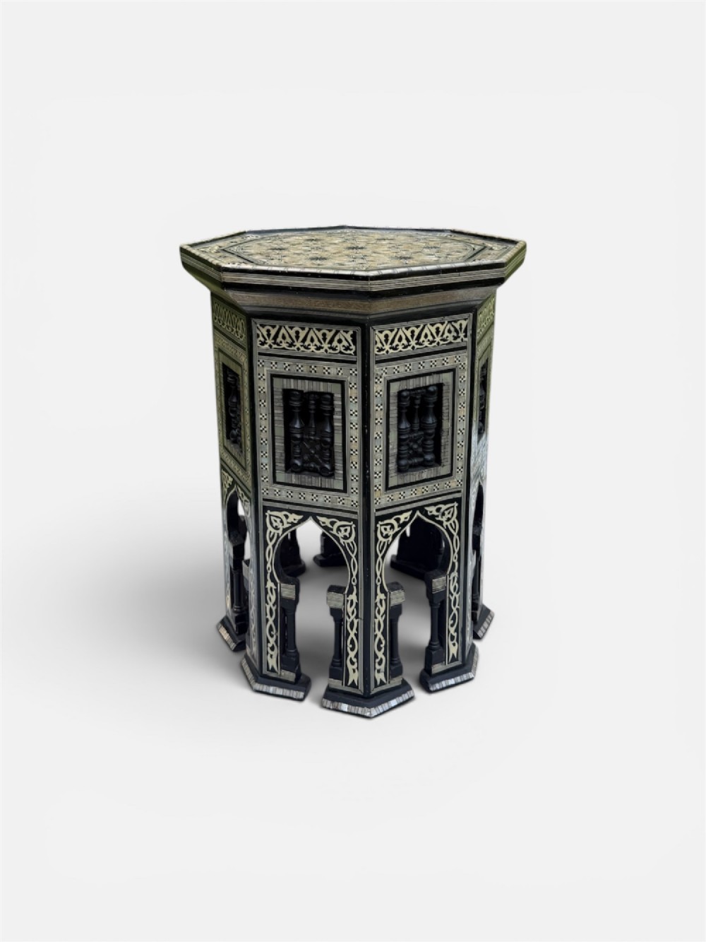 A 19th-century octagonal side table constructed from dark wood intricately inlaid with geometric mother-of-pearl star patterns and arched apron motifs. View IV