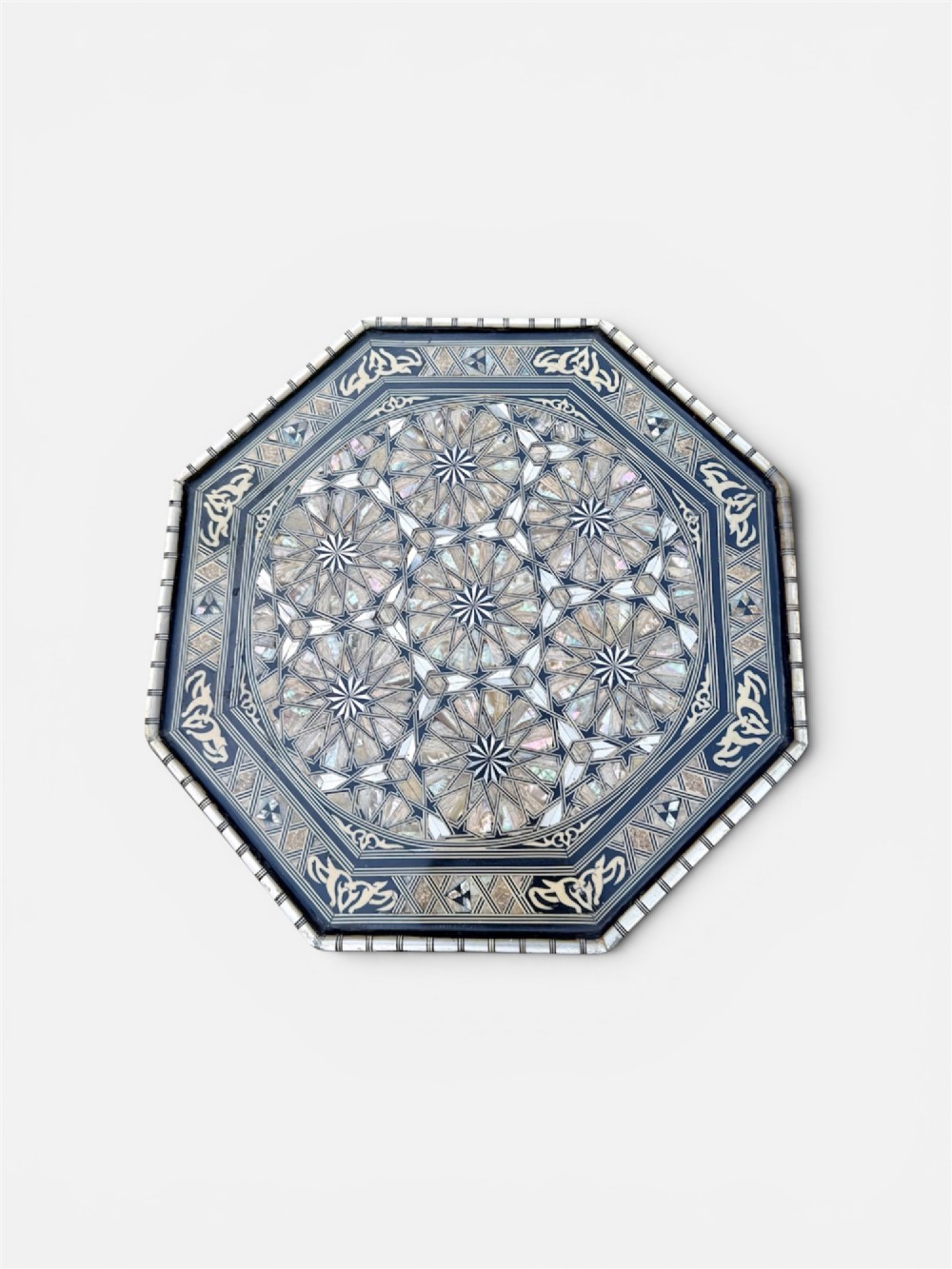 A 19th-century octagonal side table constructed from dark wood intricately inlaid with geometric mother-of-pearl star patterns and arched apron motifs. View VI