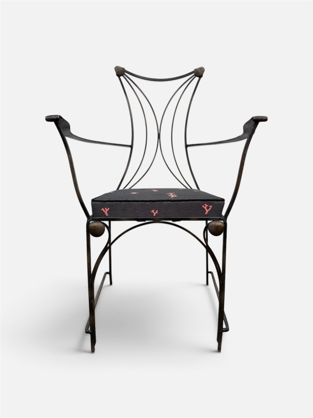 A set of six black wrought iron dining chairs featuring curved hourglass backrests, brass accents, and dark upholstered cushion seats. View VIII