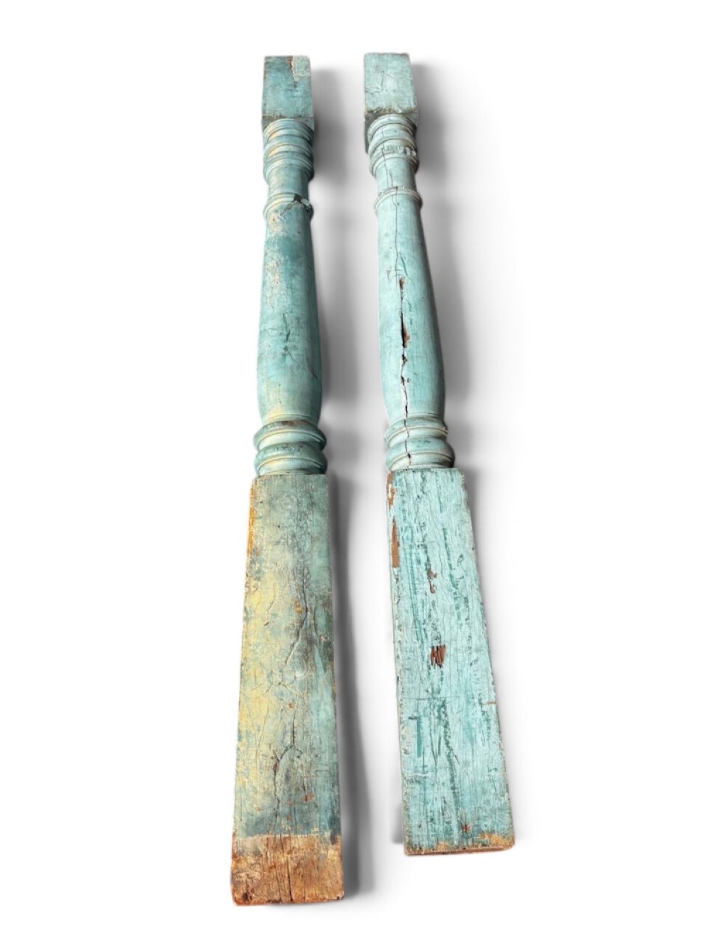 A pair of 19th-century turned hardwood architectural columns featuring a weathered blue-green painted finish. View V