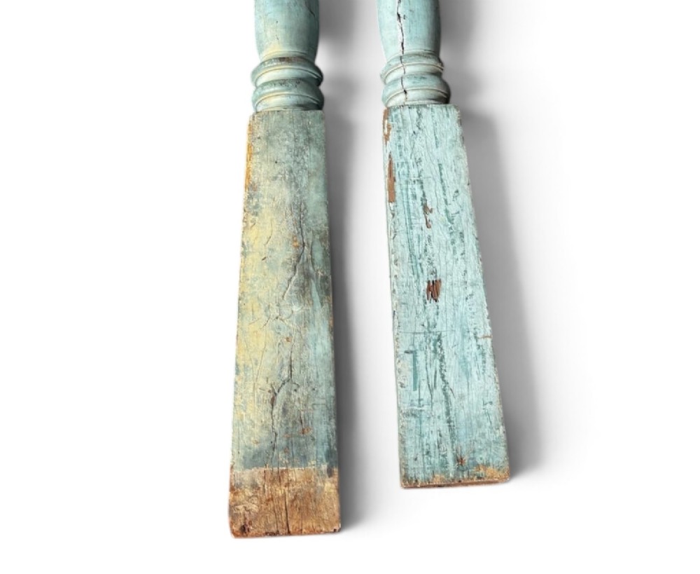 A pair of 19th-century turned hardwood architectural columns featuring a weathered blue-green painted finish. View VI