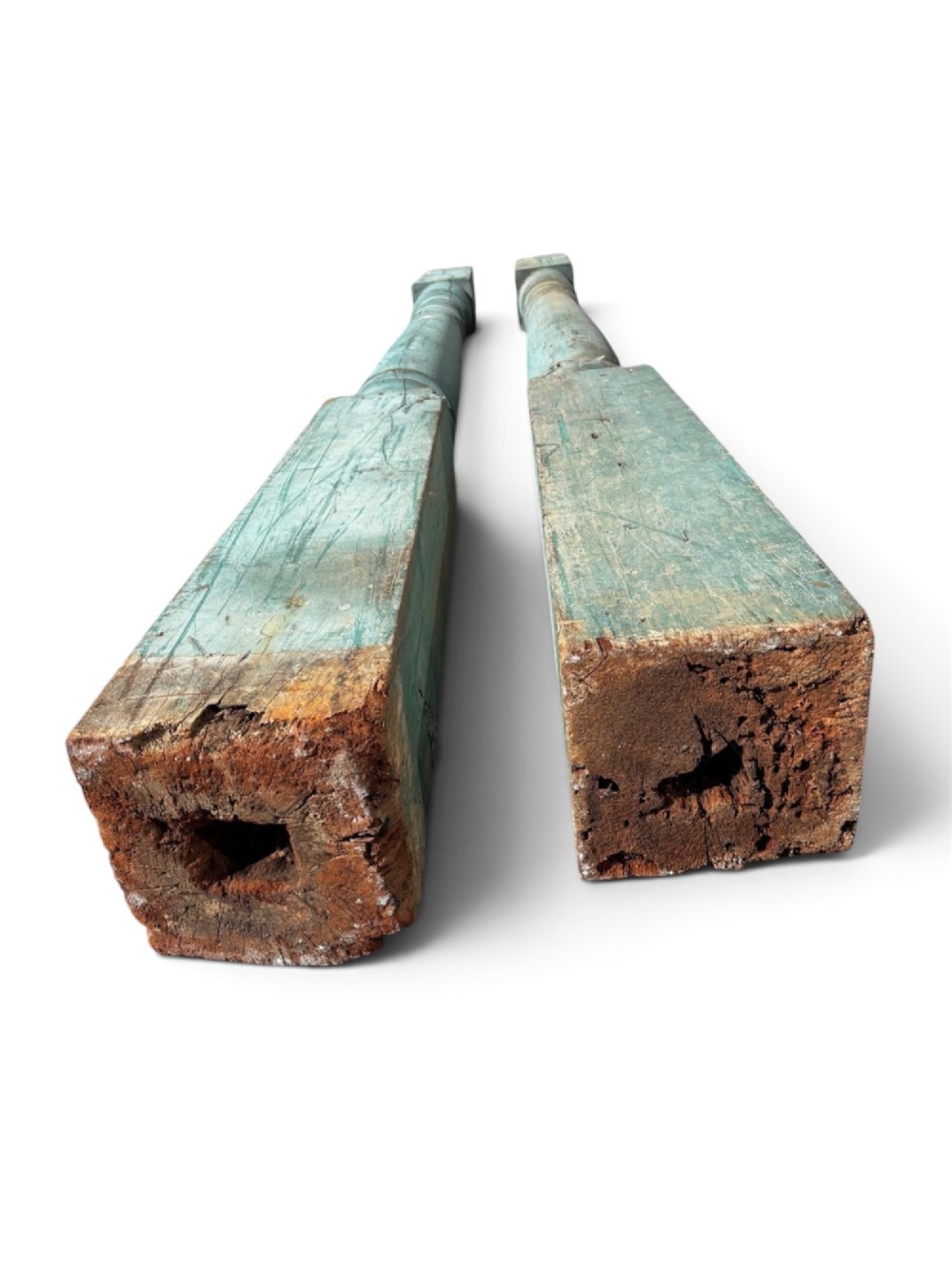 A pair of 19th-century turned hardwood architectural columns featuring a weathered blue-green painted finish. View VII