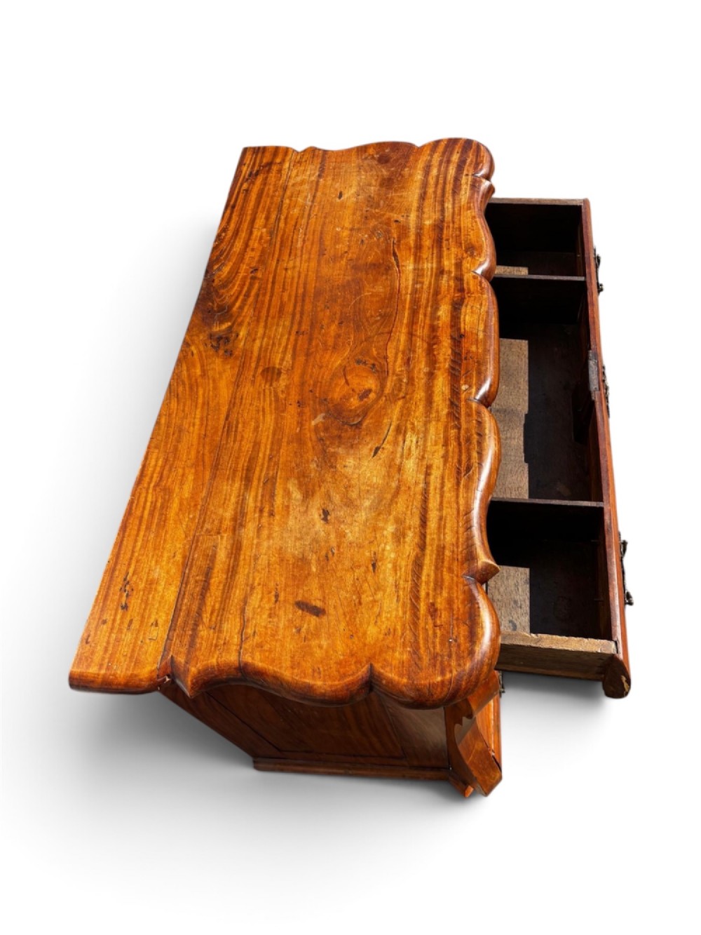 An 18th-century Dutch Colonial solid satinwood bombe chest featuring four graduated drawers, ornate brass handles, and carved feet. View III