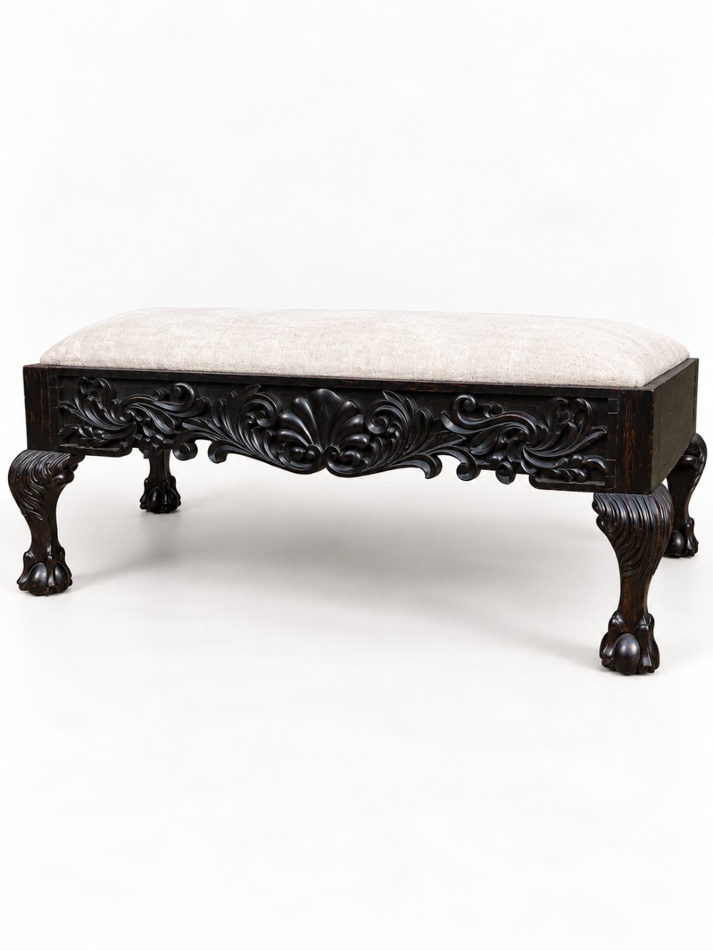 A 19th-century Ceylonese calamander wood stool featuring detailed floral relief carvings on the frame, cabriole legs with claw-and-ball feet, and neutral upholstered seat. View II
