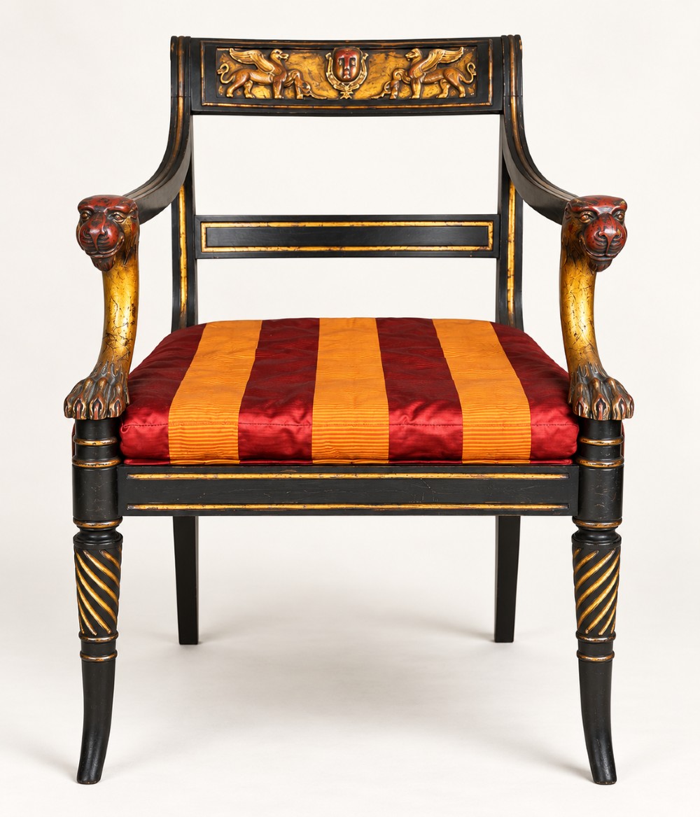 A pair of black-painted and parcel-gilt Regency style armchairs featuring lion head arm terminals, spiral-turned front legs, and red and gold striped upholstery. View II
