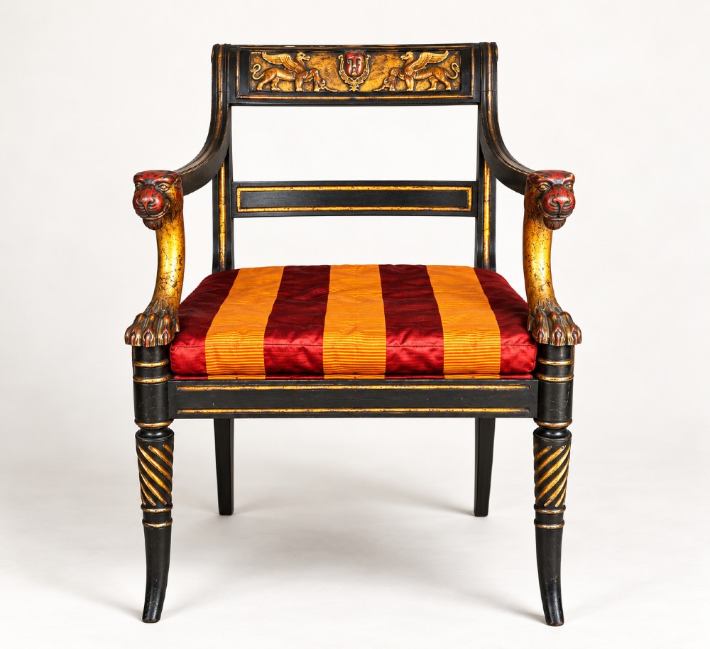 A pair of black-painted and parcel-gilt Regency style armchairs featuring lion head arm terminals, spiral-turned front legs, and red and gold striped upholstery. View III