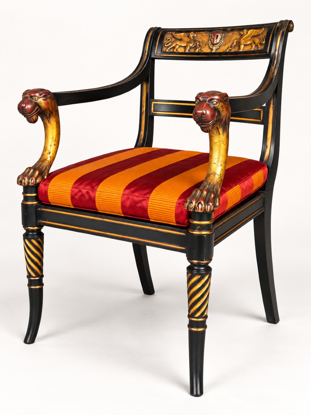 A pair of black-painted and parcel-gilt Regency style armchairs featuring lion head arm terminals, spiral-turned front legs, and red and gold striped upholstery. View IV
