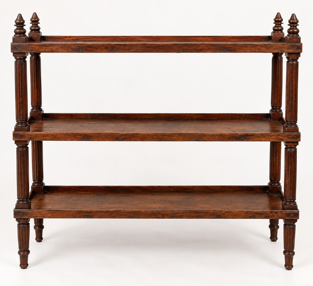 An early 19th-century dark hardwood three-tier open shelving unit featuring fluted vertical columns, turned legs, and carved top finials. View II