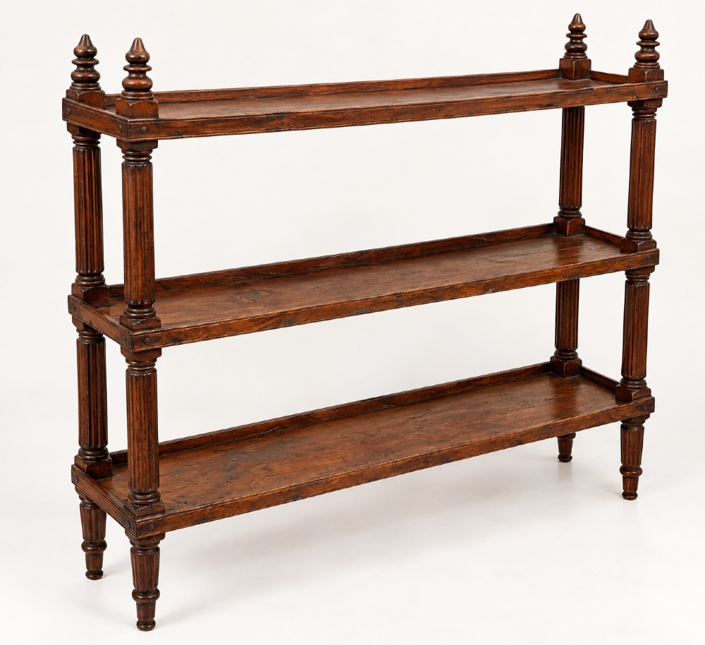 An early 19th-century dark hardwood three-tier open shelving unit featuring fluted vertical columns, turned legs, and carved top finials. View III