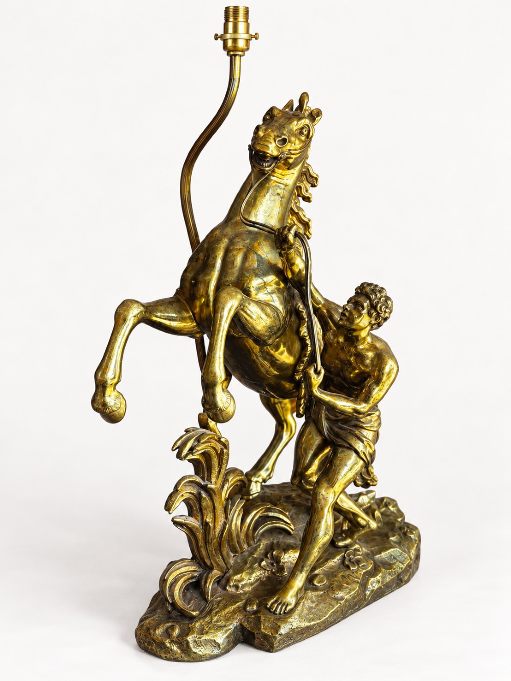 A sculptural brass table lamp depicting a rearing horse and groom after Guillaume Coustou, topped with a tall cylindrical gold leaf drum shade. View IV