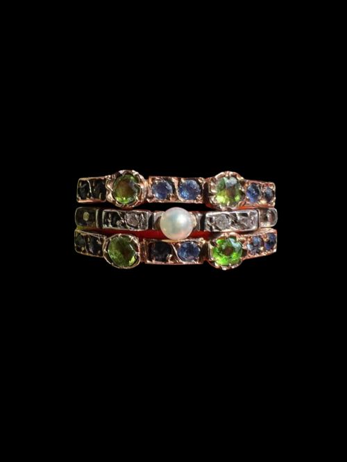 fig 1. An Edwardian multi-band harem ring crafted in gold and silver, set with green and blue gemstones, diamonds, and a central pearl.