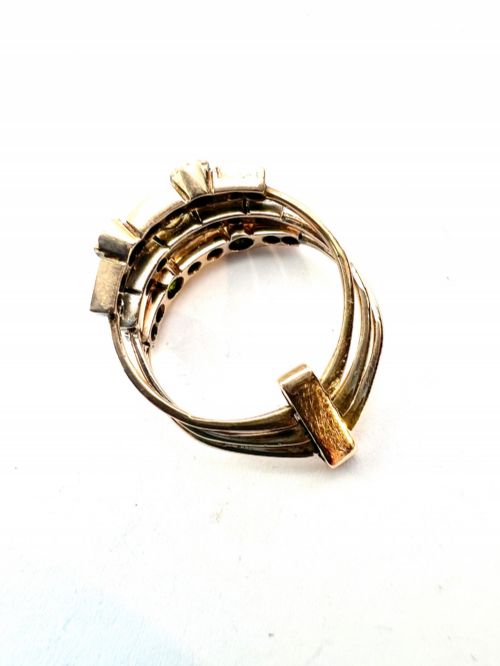 fig 2. An Edwardian multi-band harem ring crafted in gold and silver, set with green and blue gemstones, diamonds, and a central pearl.