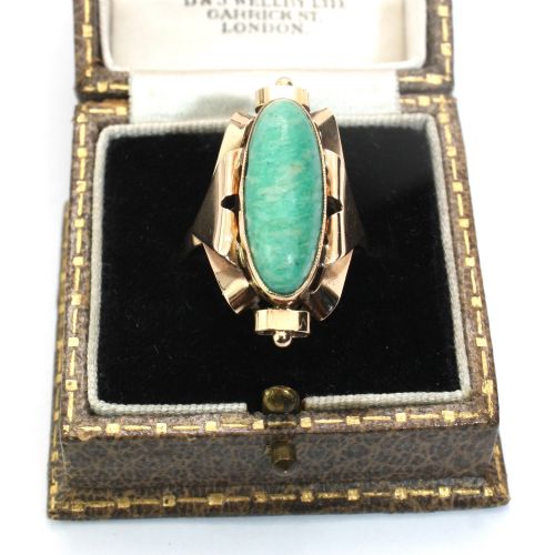 fig 1. A 1940s gold cocktail ring featuring an elongated green aventurine cabochon set within sculptural scrolled side accents.
