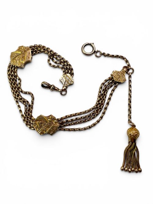 fig 2. An antique 9ct yellow gold Albertina watch chain featuring four strands, decorative engraved slides, a swivel clasp, and a dangling tassel.