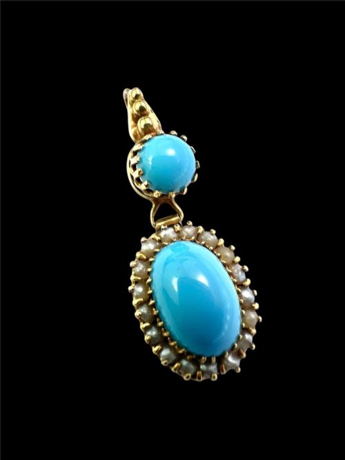 fig 1. A Victorian yellow gold drop pendant featuring an oval turquoise cabochon framed by a seed pearl halo, hanging below a smaller round turquoise stone.