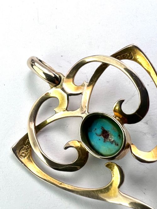 fig 1. An Art Nouveau 9ct yellow gold openwork heart-shaped pendant set with a central turquoise cabochon and a dangling oval turquoise stone.