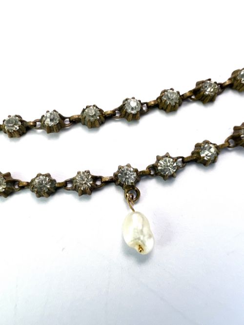 fig 1. A Victorian silver-tone chain linked with round faceted paste glass stones and featuring a singular natural pearl drop at the centre.