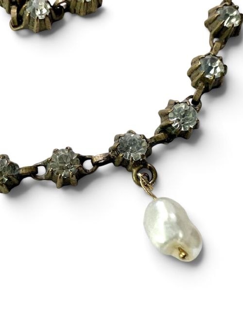A Victorian silver-tone chain linked with round faceted paste glass stones and featuring a singular natural pearl drop at the centre. View VII