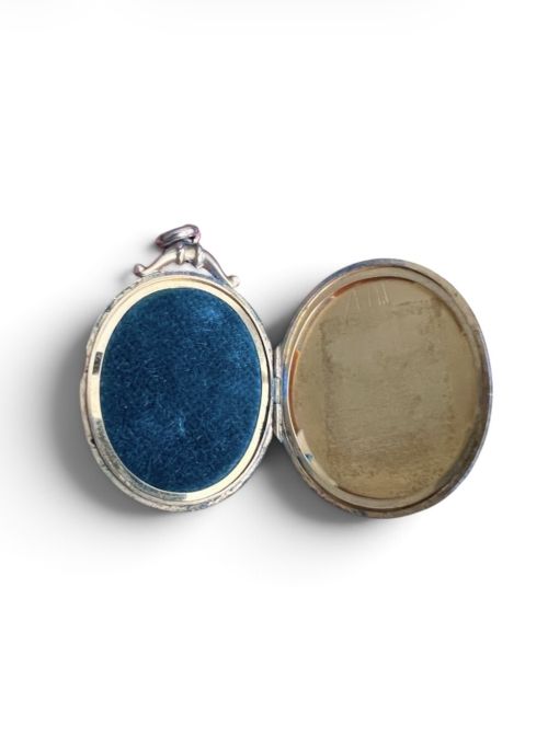 An oval 9ct yellow gold Victorian locket decorated with foliate engraving and inlaid with rubies and seed pearls. View V