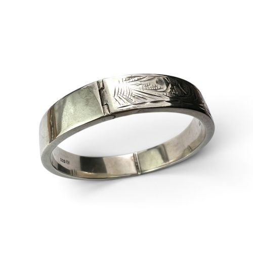 fig 2. A sterling silver hinged bangle decorated with engraved foliate motifs and visible internal makers hallmarks.