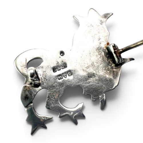 A cast sterling silver brooch shaped like a crowned heraldic lion in raised relief. View III