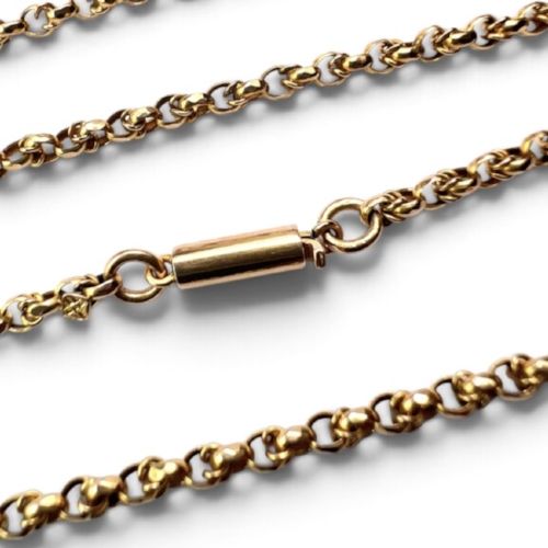 An Edwardian 9ct gold chain necklace coiled flat against a neutral white background displaying rope links and a cylindrical clasp. View III
