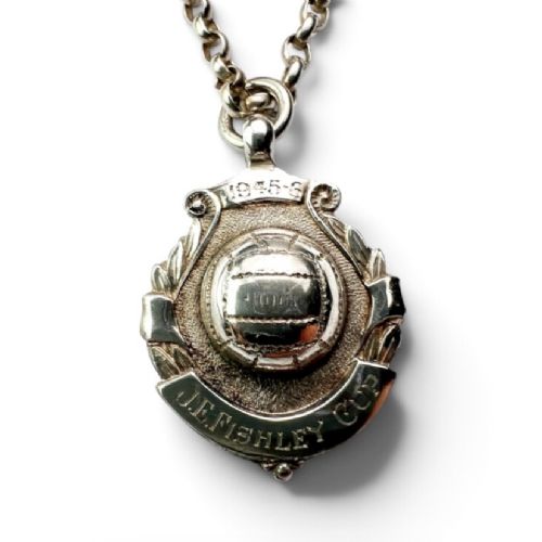 A sterling silver chain necklace featuring a shield-shaped football medal pendant engraved with 1945-6 and JR Fishley Cup. View VIII