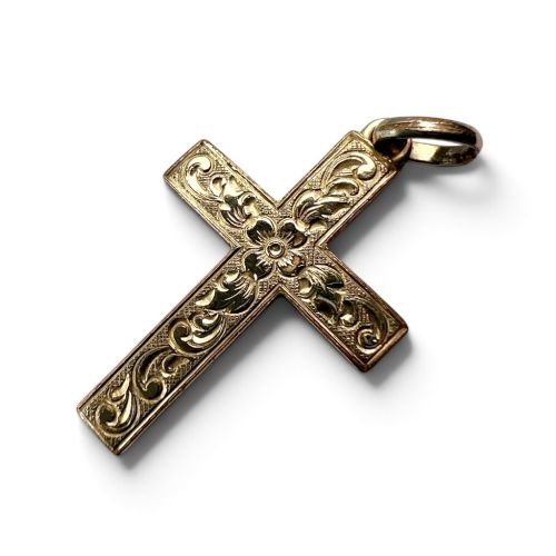 fig 1. A Victorian rolled gold cross pendant featuring hand-engraved floral and scrollwork motifs with a suspension loop at the top.