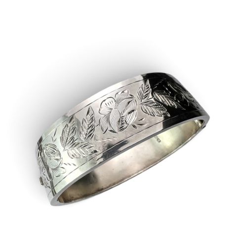 fig 1. An antique Victorian sterling silver hinged bangle with hand-engraved floral and leaf motifs and interior hallmarks.